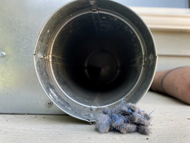 Port St. Lucie Dryer Vent Cleaning technician using specialized equipment to clear severe dryer vent blockage in Port St. Lucie